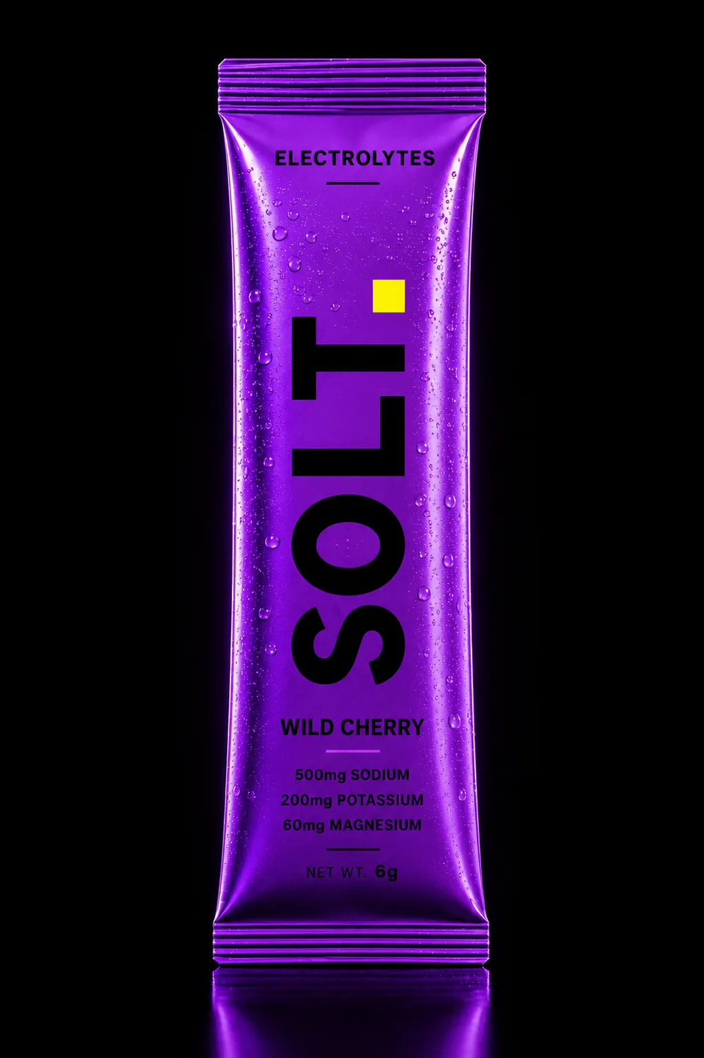 SOLT Wild Cherry sachet, vivid purple pack on a dark stage. Real Himalayan salt, zero sugar.